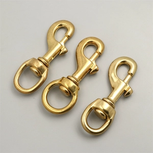 Detailed view of three solid brass swivel snap hooks with spring gate for bags and pets