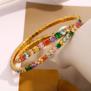 Detailed close-up of two gold-plated rainbow bracelets with colorful cubic zirconia stones