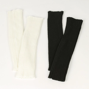 Detailed close-up of ribbed knit texture on white and black slouchy leg warmers