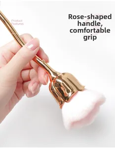 Detail of rose flower nail dust brush with pink gradient bristles and gold metal stem