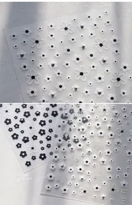 Detail of 3D embossed floral nail stickers with pearls in black and white styles