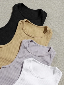 Detail of ribbed knit texture on solid color slim fit yoga tank tops in four neutral colors
