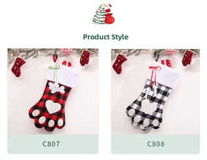 Detail of buffalo plaid dog paw Christmas stockings with plush trim and bone charms