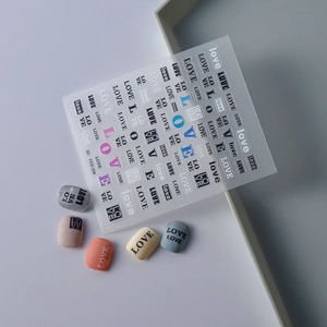 Detail of 5D embossed nail stickers FEB-358 with LOVE lettering and colorful nail samples