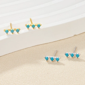 Detailed macro view of S925 silver stud earrings with three round blue zircon stones
