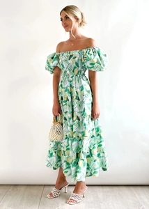 Detail of off-shoulder puff sleeve floral dress with tiered skirt and colorful abstract print