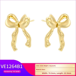 Detail view of golden bow earrings in brass with dimensions and weight specs