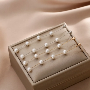 Elegant long freshwater pearl drop earrings in gold and silver finish with five pearls