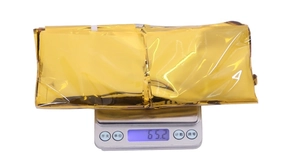 Detailed view of lightweight 65g golden foil party curtain folded for compact storage