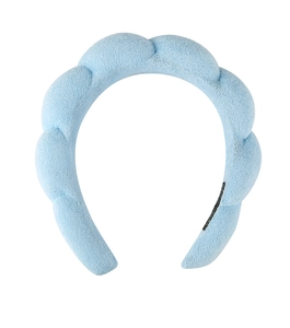 Close-up of light blue thick sponge headband with soft terry cloth texture details