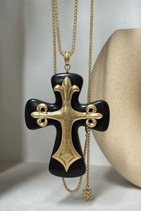Detail shot of Gothic resin cross pendant with ornate gold floral metal inlay and chain