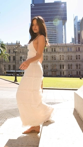 Close-up of white tiered chiffon maxi dress with fine texture and layered skirt detail