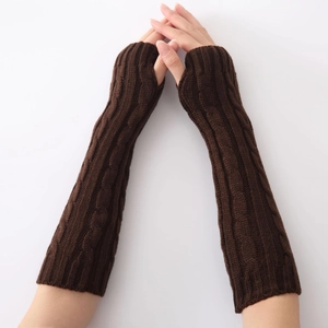 Detailed close-up of dark brown cable knit fingerless gloves with texture and long design