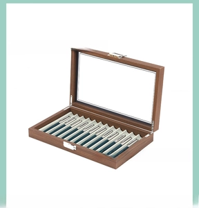 Detail of 12-slot walnut wood pen display box with clear glass window and metal lock