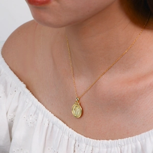 Close-up of 925 sterling silver vintage coin necklace with Queen Elizabeth II relief