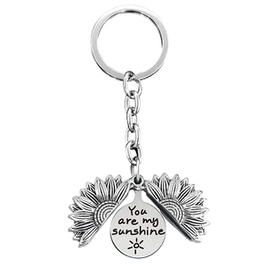 Detail of opening sunflower pendant keychain with You are my sunshine engraving