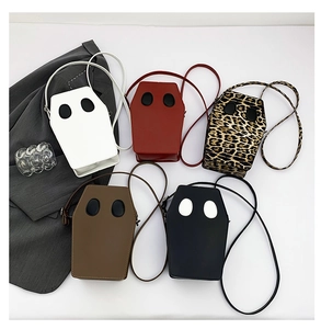 Flat lay view of unique coffin shaped crossbody bags in five stylish color variations