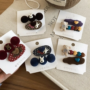 Detail showing flocked puppy and bear hair clips set with heart and polka dot patterns