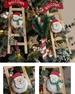 Detail of wooden Christmas ladder ornament with Santa Claus, Snowman and XMAS text