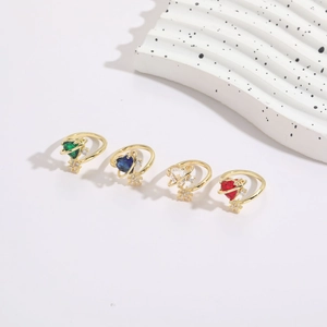 Detail of four heart-shaped zircon rings in gold plating with cosmic star accents
