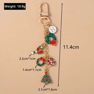 Detailed view of Christmas keychain with enamel tree, wreath, and size specifications