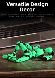 Articulated 3D printed robot figure in neon green and black on a wooden desk