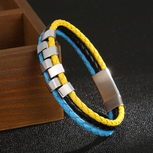 Close-up of multi-layer woven leather bracelet with silver magnetic clasp on wood