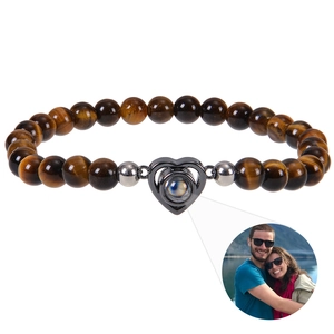 Detail of heart projection bracelet with tiger eye beads and custom photo inner view