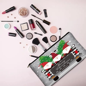 Christmas makeup bag featuring festive gnomes and truck on a gray gradient background