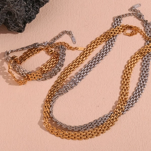 Close-up of gold and silver 18K plated tank chain bracelet and necklace set