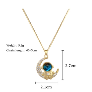 Detail view of astronaut on moon pendant with product dimensions and 5.2g weight