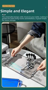Close-up of hands holding a grey tray with silver handles and a checkered glass cup