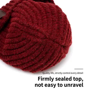 Top view of a thick dark red knit beanie showing sturdy spiral stitching detail