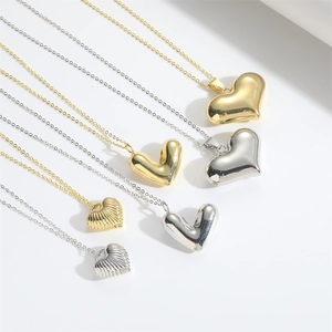 Vintage gold and silver heart necklaces with striped love patterns in various sizes