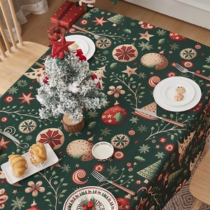 Close-up of dark green Christmas tablecloth with festive star and snowflake patterns