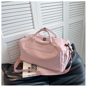 Detailed macro view of pink nylon fitness bag with sturdy handles and Yummy Bag patch