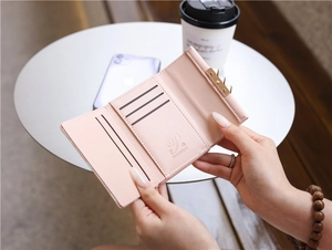 Detailed view of the pink floral tri-fold wallet interior with multiple card slots