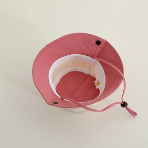 Minimalist kids sun hat with adjustable drawstring in contrast pink and beige canvas