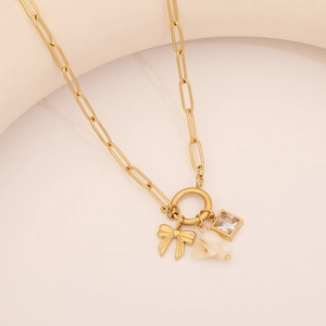 Gold paperclip necklace with bow charm, natural stone pendant and square zircon accent
