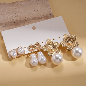 Detail of 6-piece earring set featuring gold-tone flower, baroque pearl and rhinestone charms