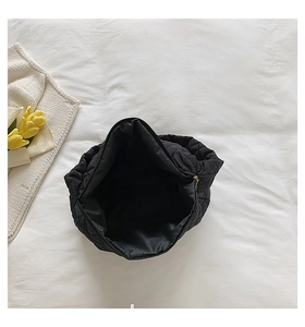 Top view of large black quilted dumpling bag showing spacious interior and zipper closure