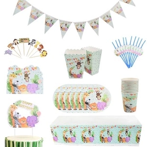 Flat lay of forest animal safari party supplies including plates cups and cake toppers