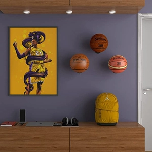 Wall-mounted black iron ball rack for basketball and soccer storage in home gym setup