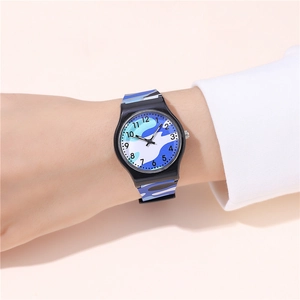 Close-up of kids quartz watch with blue camouflage strap worn on the wrist