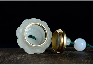 Detailed macro view of lotus-shaped sandalwood diffuser jar with golden metal lid