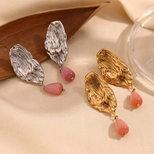 Detail of 18K gold plated butterfly wing earrings with teardrop pink stone pendants