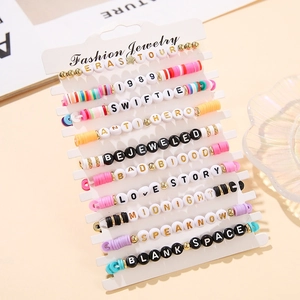 Detail of Taylor Swift themed colorful clay bead friendship bracelets set on display card