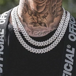Double layered silver cuban link necklace with full diamond inlay on a male model's neck