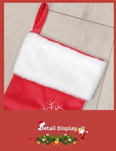 Detail of red Christmas stocking with white faux fur trim and embroidered snowflake