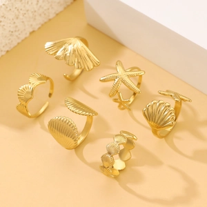 Golden ocean theme rings detail showing starfish, seashell and pleated fan designs